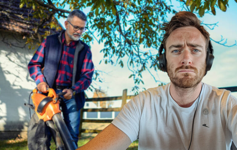 man on headphones with leafblower man in background