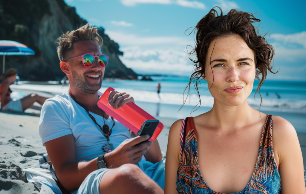 man with bluetooth speaker on beach and woman looking unimpressed.