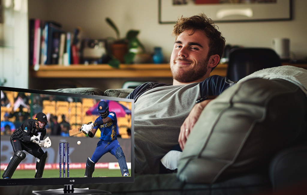 man watching cricket on couch