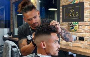 guy getting haircut at 1855 Barbers