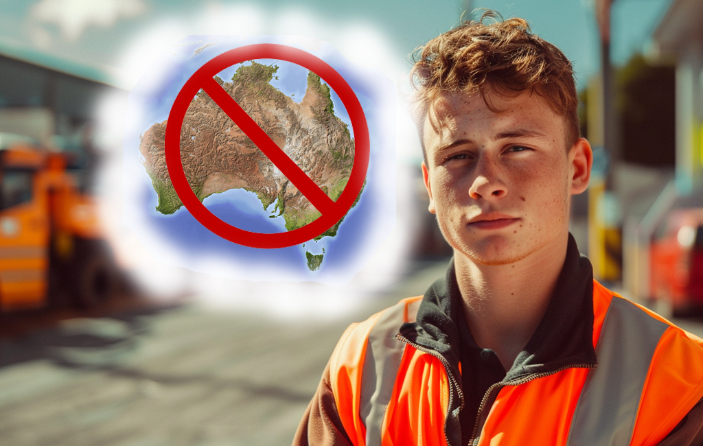 man posing in front of building site with a no Australia sign