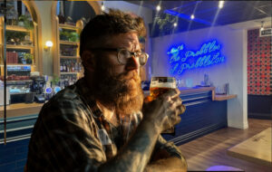 man with beer at bar