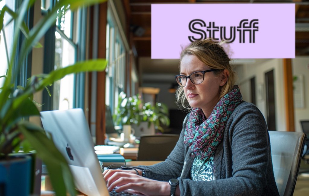 journalist at Stuff writing at laptop