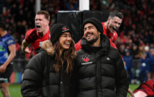 crusaders fans at game wearing black puffer jackets and beanies