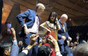 Luxon and Hipkins dancing on stage humiliatingly.