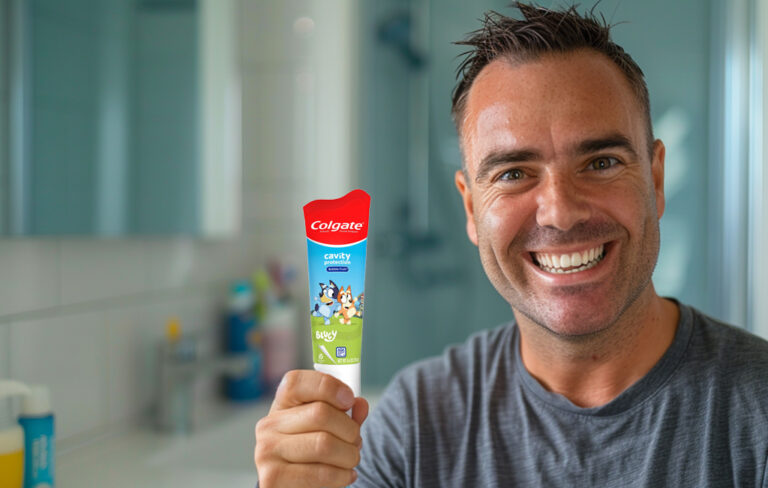 man holding bluey toothpaste in the bathroom