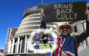 Man protesting about Christian Cullen outside the beehive.