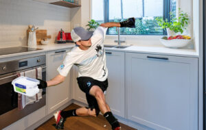 man chucking sistema container in kitchen