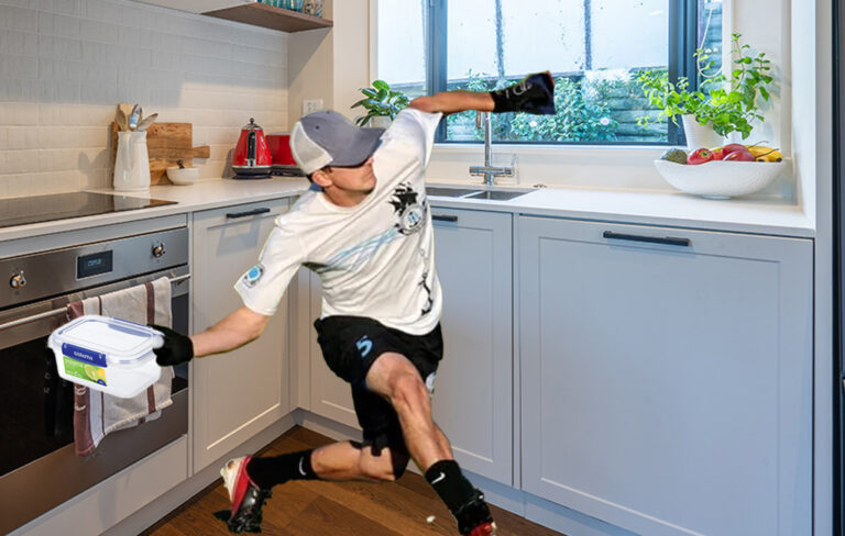 man chucking sistema container in kitchen