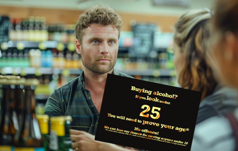 man buying beers at checkout