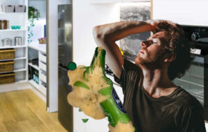 man facepalming after exploding beer in freezer.