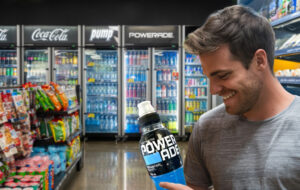 man looking at powerade bottle in Night n day store.