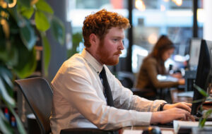 man busily working at his desk.