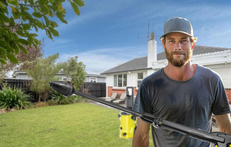man in backyard with waterblaster