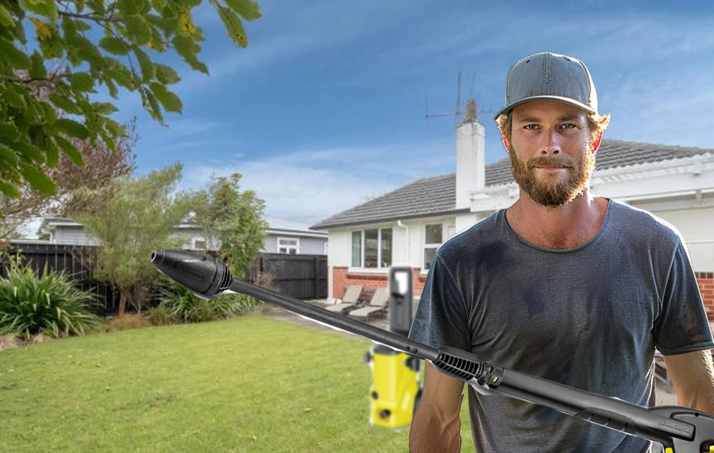 man in backyard with waterblaster