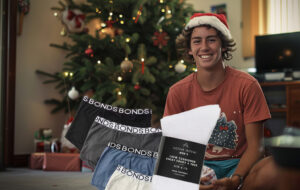 lad sitting by xmas tree with socks and undies