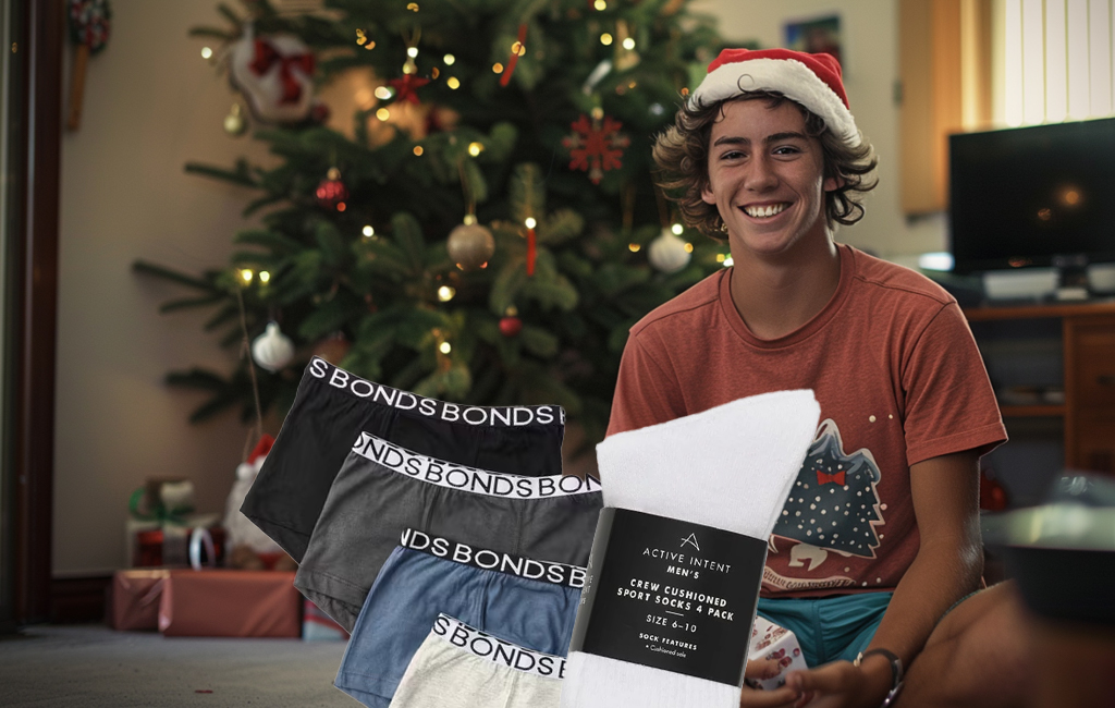 lad sitting by xmas tree with socks and undies