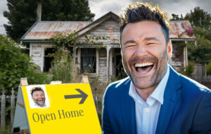 real estate agent laughing in front of house for sale.