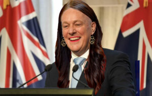 christopher luxon with long hair and lipstick