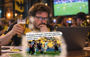man on laptop with beer at pub